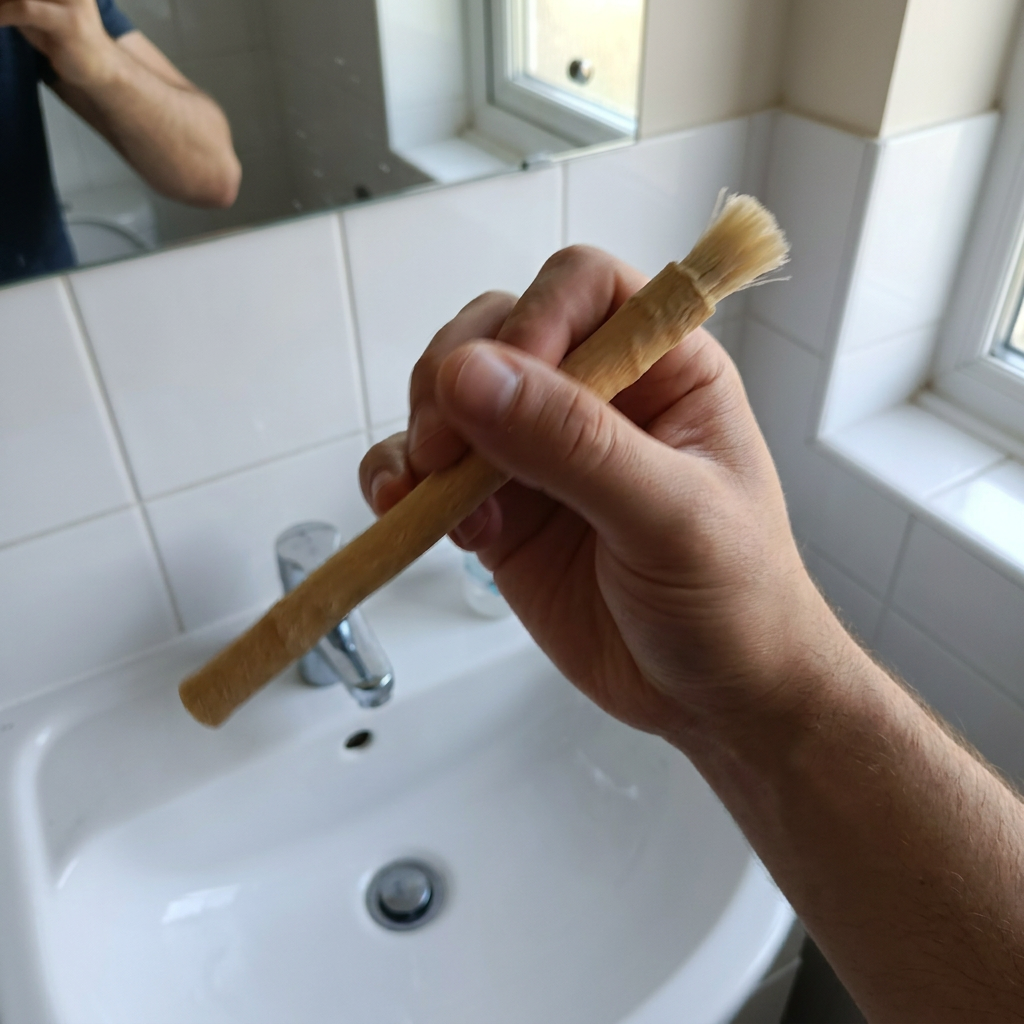 A SiwakStick rinsed under a bathroom tap
